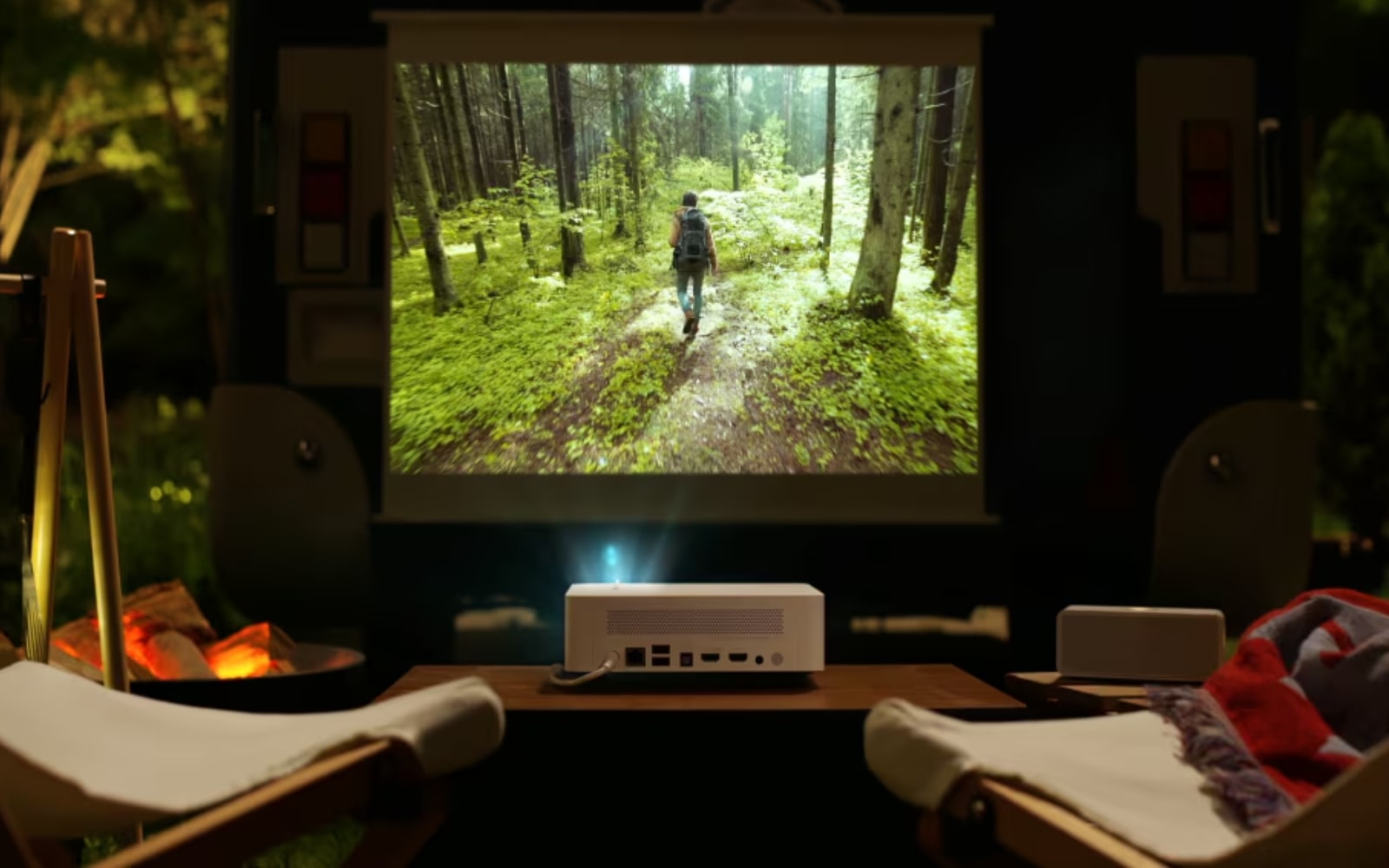 Outdoor setup featuring an LG projector screening a nature documentary, creating a cozy atmosphere perfect for camping movie nights.