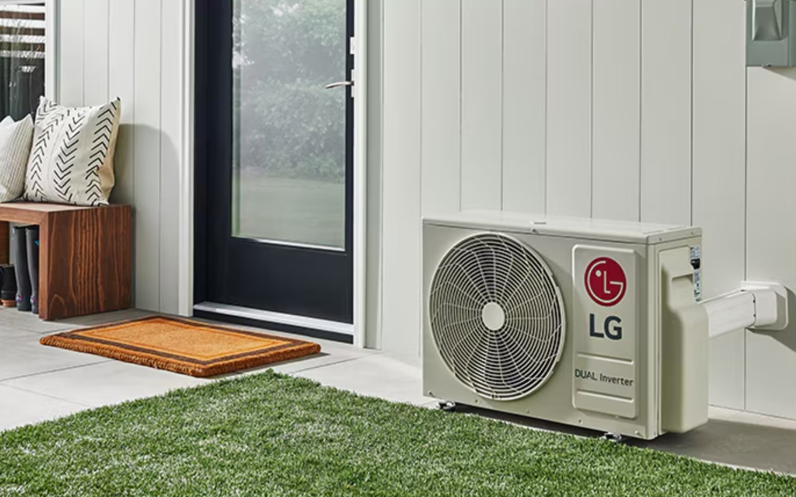 Alt text: An LG Heat Pump system installed outside a home in a sunny environment.