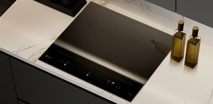 The glossy black glass finish of the induction cooktop.
