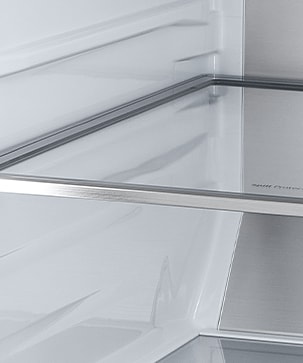 A diagonal view of the shelf with metallic paneling on the interior of the refrigerator.