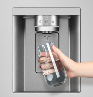 A person is getting water from the refrigerator dispenser into a glass