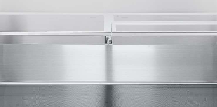 A diagonal view of the shelf with metallic paneling on the interior of the refrigerator.