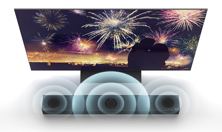 In bird's eye view, LG TV is standing on the floor and LG Sound bar is right below TV in the infinite space. On the TV screen, a silhouette of a couple on the background of fireworks. Soundwave graphics are coming from the center, left, and right speaker of the top of sound bar.