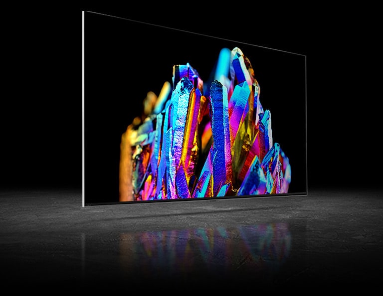 There are two TV screens – one on left another on right. There are same images of a colorful crystal on each TV. An image on left is a bit pale while an image on right is very vivid. There is a processor chip image on left bottom corner of a TV on right image.