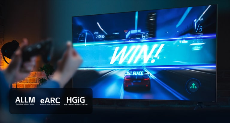An image of LG TV showing a car racing game on the finish line, with the sign saying 'WIN!', as the player clenches on to the game joystick. ALLM, eARC, HGiG logo are place on the bottom left corner.