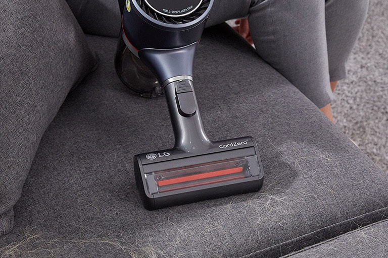 Three images in line: the first shows the vacuum vacuuming dirt from a hard surface, second shows vacuuming chips from a carpet, and the third shows the Power Punch on bedding.