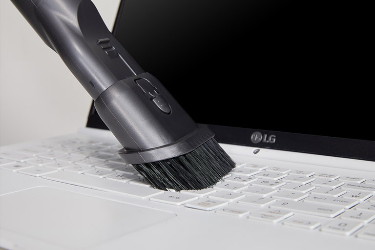 Three images: the first shows the crevice tool picking up snacks from a carseat, the second shows the brush being used on a keyboard, and the third shows the mattress tool used on a mattress.