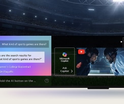 Close-up of an LG QNED TV screen showing how AI Search works. A small chat window is open showing how the user asked for what sports games are available. AI search responded via chat and by showing thumbnails of available content. There is also a prompt to ask Microsoft Copilot.