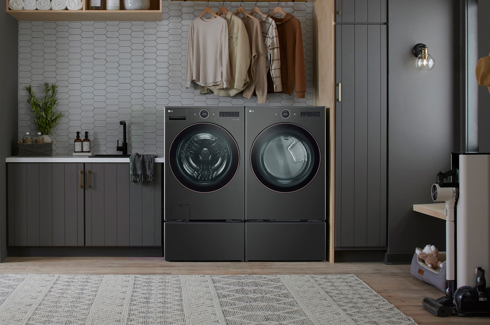 The LG Front Load Washer and Dryer set (WM6500HBA) in Black Steel, showcasing its premium aesthetic and seamless integration into a dark, modern, and stylish laundry room.