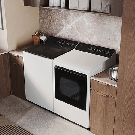 The LG Top Load Washer and Dryer set (WT8400CW) in White, showcasing its premium, side-by-side design seamlessly integrated into a luxurious laundry room with marble and wood finishes.