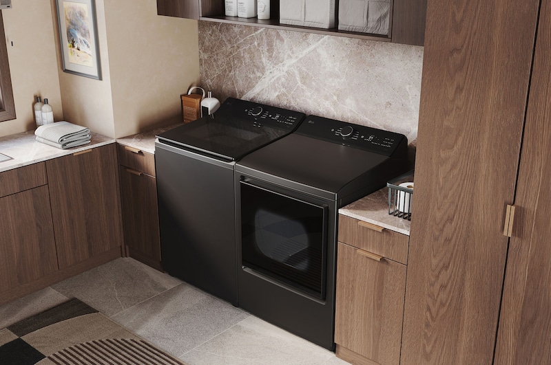 The LG Top Load Washer and Dryer set (WT8400CB) in Black Steel, showcasing the flat-top design and premium finish integrated perfectly beneath the upper cabinetry.