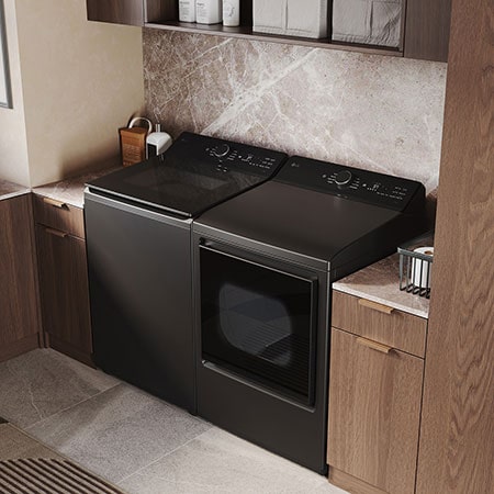 The LG Top Load Washer and Dryer set (WT8400CB) in Black Steel, showcasing the flat-top design and premium finish integrated perfectly beneath the upper cabinetry.