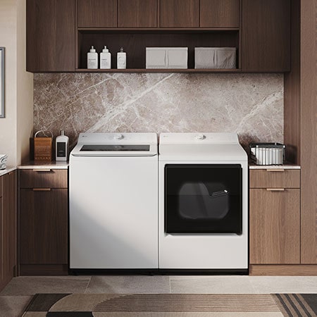 The LG Top Load Washer and Dryer set (WT8205CW) in White, showcasing the flat-top design and clean finish integrated perfectly beneath the upper cabinetry.