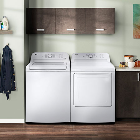 The LG Top Load Washer and Dryer set (DLE6100W) in White, showcasing its classic aesthetic and seamless side-by-side integration into a modern laundry room.