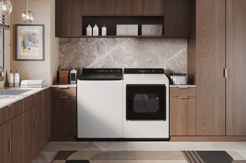 The LG Top Load Washer and Dryer set (DLE8400WE) in White, showcasing the flat-top design and clean finish integrated perfectly beneath the upper cabinetry.