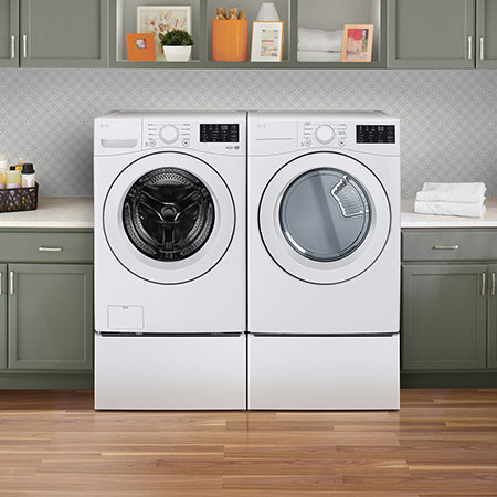 The LG Front Load Washer and Dryer set (DLE3470W) in White, showcasing its classic aesthetic and seamless side-by-side integration on pedestals in a modern laundry room.