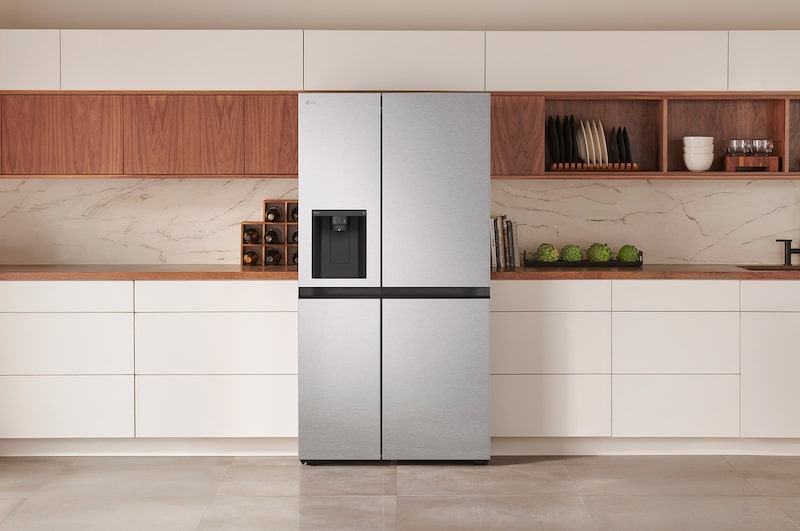 The stainless steel finish LG 36-inch 29 cu.ft. Smart Side-by-Side Refrigerator LS29S3230V with water dispenser, shown installed in a modern kitchen.