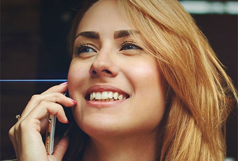 From left to right: A woman is talking on the phone outside wearing T80S, T80S filters out background noise, and the other woman can hear only her voice clearly.