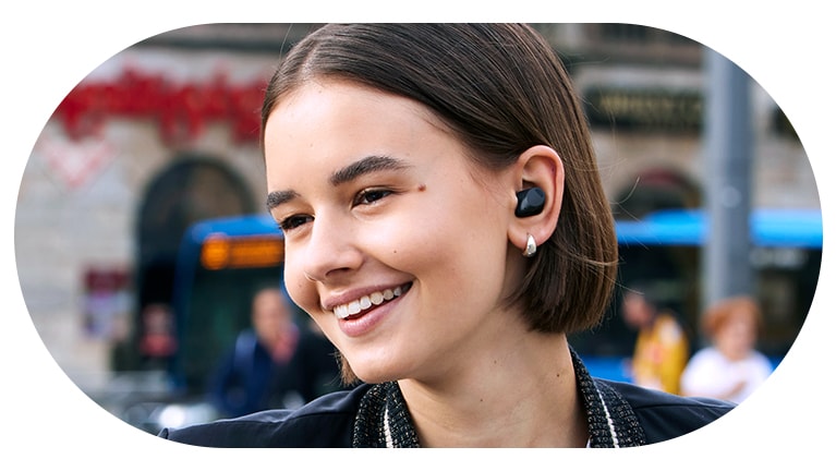 A woman wearing the T80S and using the listening mode.