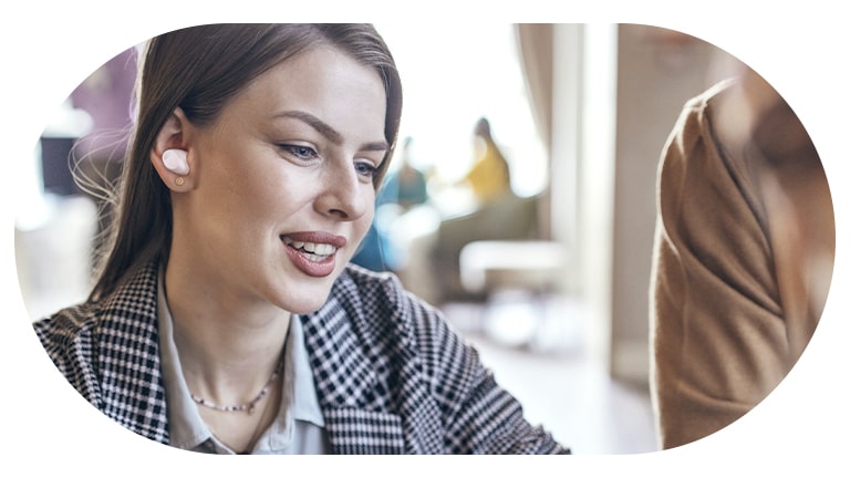 A woman wearing the T80S and using the conversation mode.