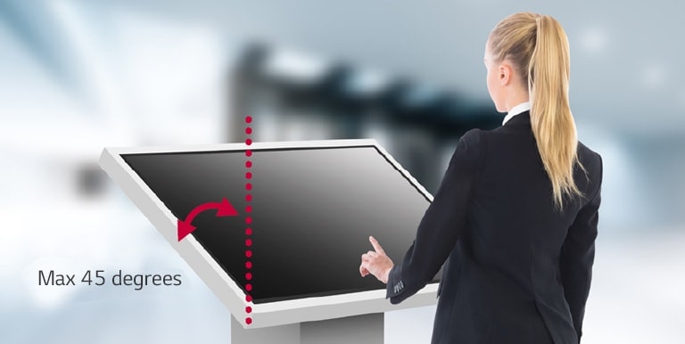 A woman is touching a lower installed TNF5J. The TNF5J is installed tilted toward the woman so she can see the display content well.