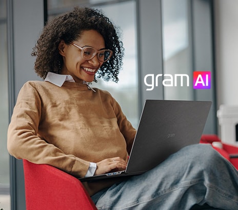 The image shows a smiling woman using a laptop while seated in a modern, cozy setting. The text reads: "Your own AI secretary" alongside the "gram AI" logo, emphasizing the device's AI-powered assistant features.