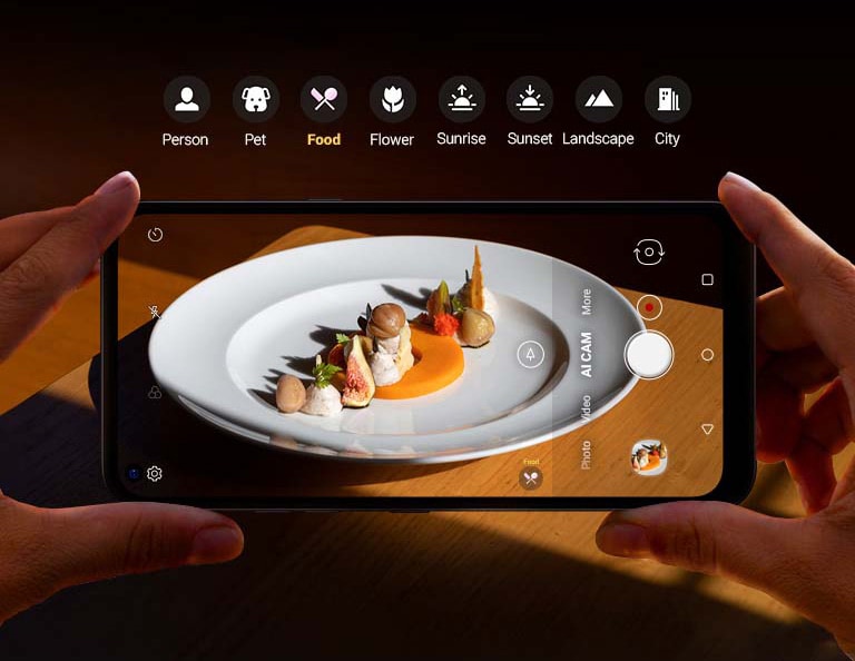 Closeup of someone holding a smartphone shooting food