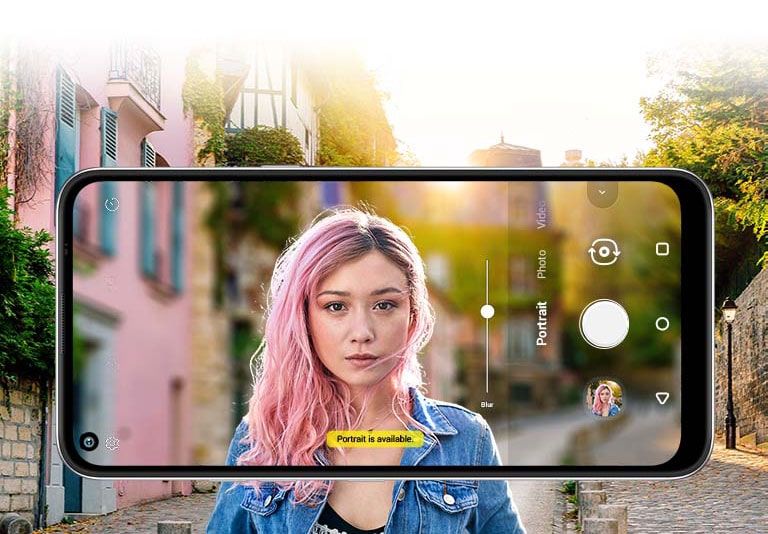 Woman taking a selfie behind a street