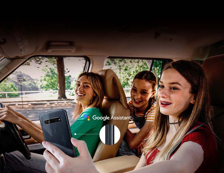 Woman searching with her smartphone in the car using google assistant function