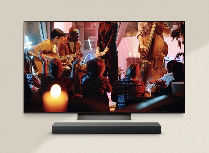 A cozy concert is playing on an LG TV with an LG Soundbar underneath.