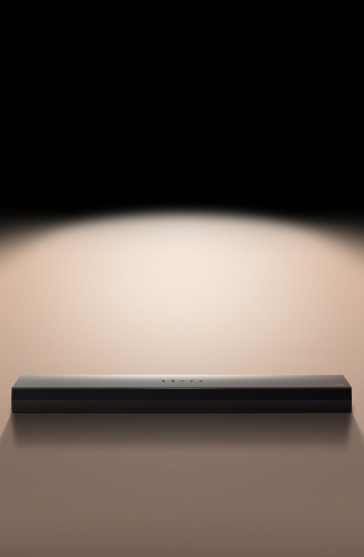 LG Soundbar against a black backdrop highlighted by a spotlight. 		