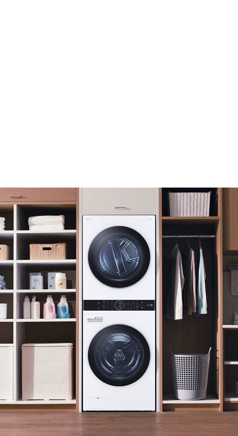 LG stacked washer and dryer in a modern laundry room, flanked by shelves with baskets and cleaning supplies.