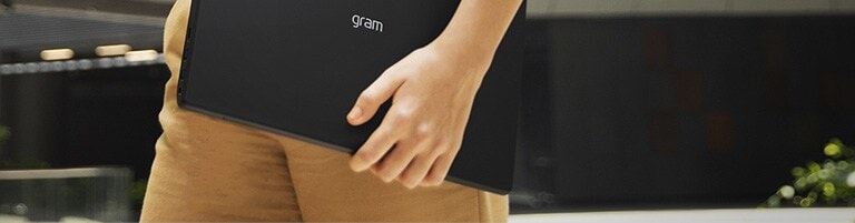 A woman is on the move while holding LG gram.