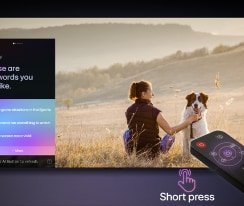 LG AI Magic Remote vor einem LG TV-Bildschirm. Auf dem Bildschirm erscheint eine personalisierte Begrüßung durch die LG KI mit benutzerdefinierten Schlüsselwörtern, die auf dem Such- und Sehverlauf des Benutzers basieren. An der Fernbedienung befinden sich ein Symbol und ein Hinweis darauf, dass die AI Concierge-Funktion mit einem kurzen Druck auf die KI-Schaltfläche leicht zugänglich ist.