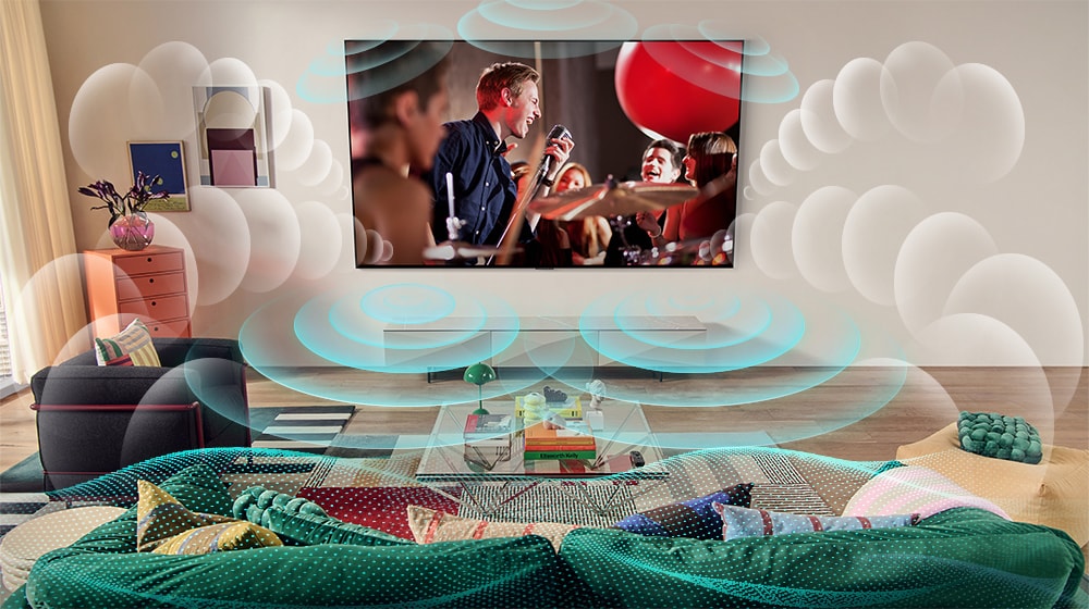 Imagen de un televisor LG OLED en una sala que muestra un concierto de música. Las burbujas que representan el sonido envolvente virtual llenan el espacio.