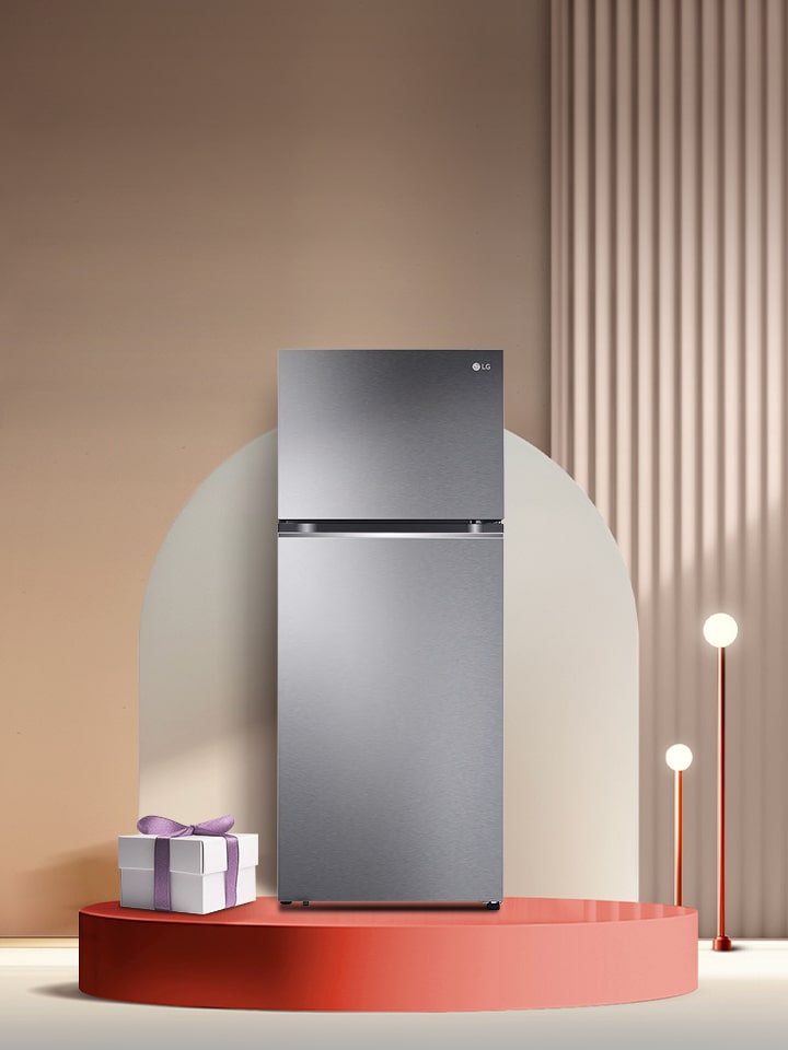 A luxurious space in beige tones has a striped wall, a white platform in the middle, a silver colored 2 door refrigerator on top of it, and several objects arranged around it.