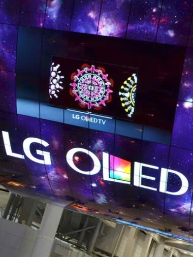 A curved OLED screen installation reading &quot;LG OLED&quot;