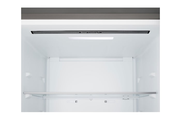 LG bottom freezer (GBBS726CPY) installed flush in tall warm beige wall with white arrows pointing to top side and front surfaces