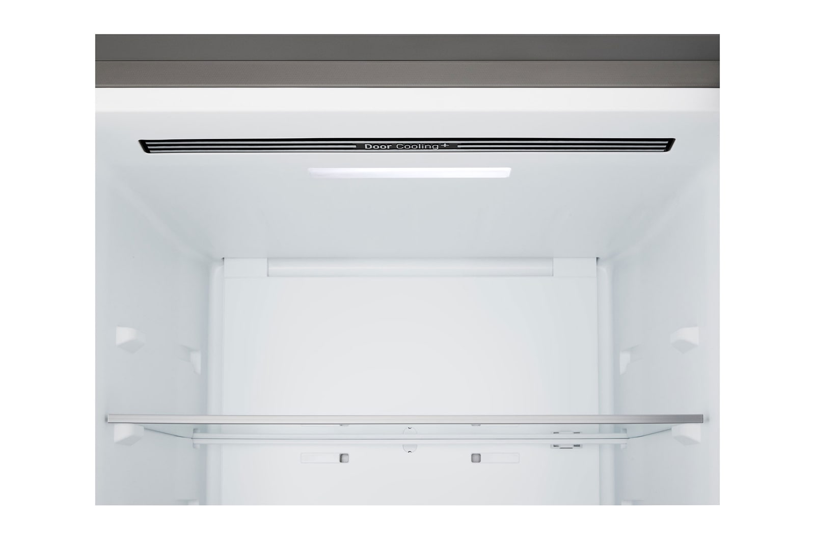 LG bottom freezer (GBBS726CPY) installed flush in tall warm beige wall with white arrows pointing to top side and front surfaces
