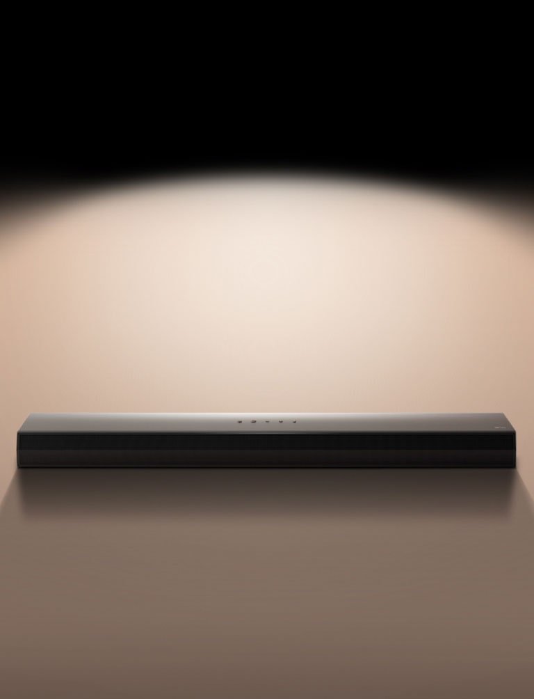 LG Soundbar mod en sort baggrund, fremhævet af et spotlight.