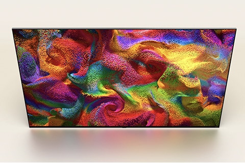 An angled overhead perspective of an LG QNED TV with an abstract, colorful artwork on screen.
