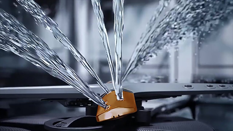 Footage of intense water streams from rotating dishwasher blades in close-up.