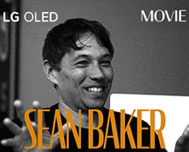 A black and white still image from an interview with Sean Baker. His name appears in bold orange letters across the bottom of the frame. The phrase LG OLED is in the top left corner, and the word movie is in the top right corner.