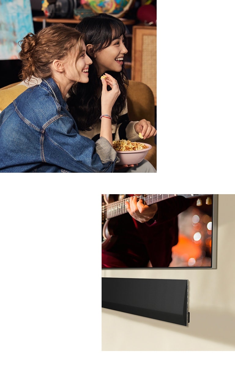 Two women sitting on a sofa eating popcorn. A close-up side angle of the bottom right corner of a wall-mounted LG TV and an LG Soundbar mounted on the wall underneath.