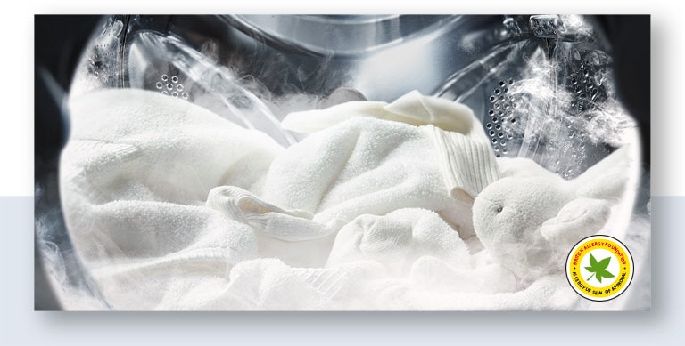 White towels and clothes in a washing machine with steam around, green star logo at the bottom right.