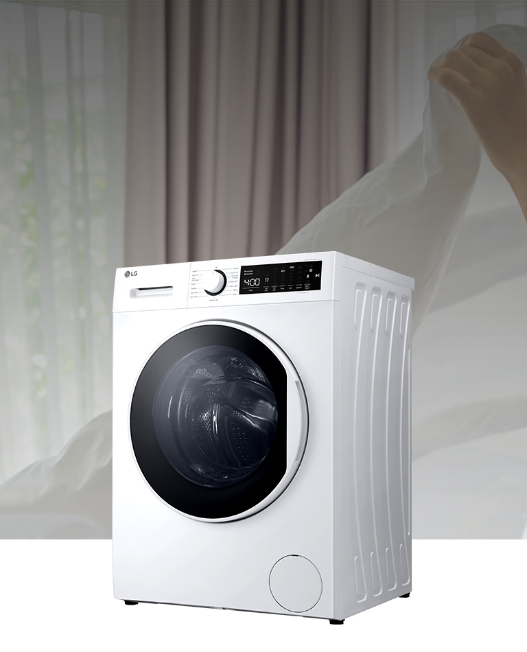 There is a washing machine in the background of spreading the white fabric.