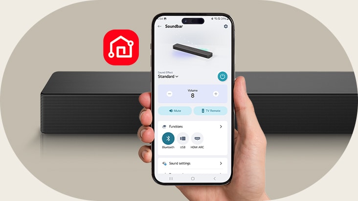 A smart phone with LG ThinQ app screen is held in a hand. Beside it LG ThinQ app icon is shown. SH5A Soundbar is placed behind.