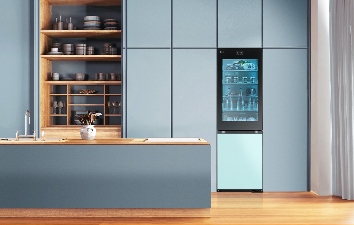 An image of a refrigerator placed in a blue-toned kitchen.