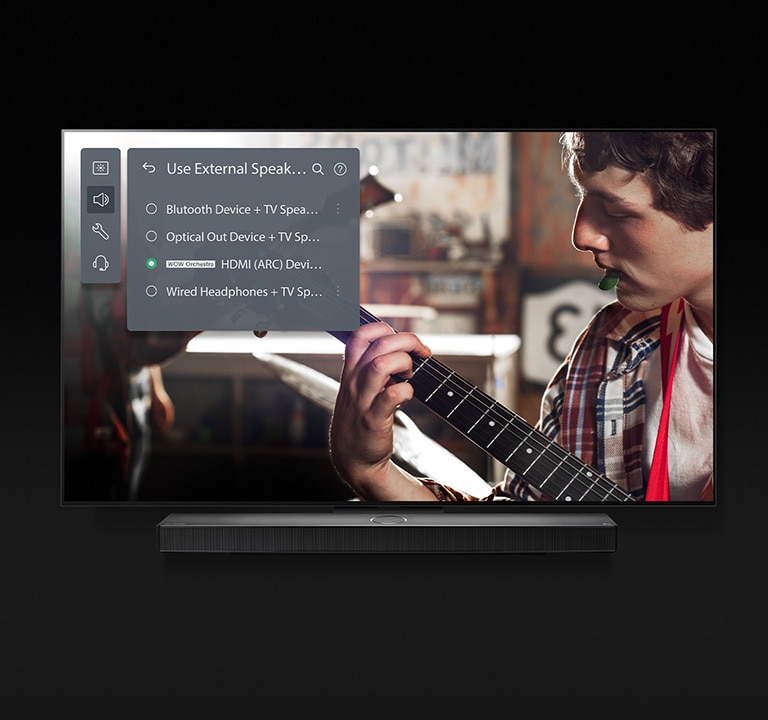 An image of an LG OLED TV with Soundbar. A video of a boy playing the guitar plays on screen with Soundbar Mode's settings overlayed on top.