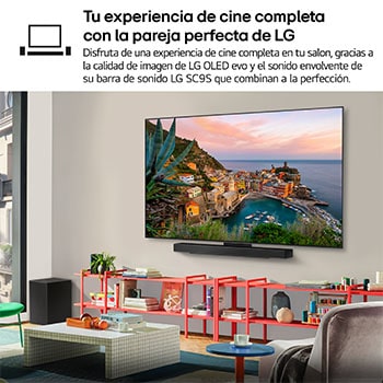Wide view of a stylish and colorful living room. LG OLED evo AI C5E 4K Smart TV is mounted on the wall with an LG Soundbar underneath it. The TV's design blends well with the space. On the TV screen is a colorful artwork.